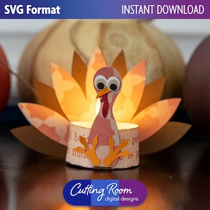 May include: A paper turkey candle holder with orange and yellow accents, set against a backdrop of pumpkins. The turkey has googly eyes and orange feet. The words "SVG Format" and "Instant Download" are visible.