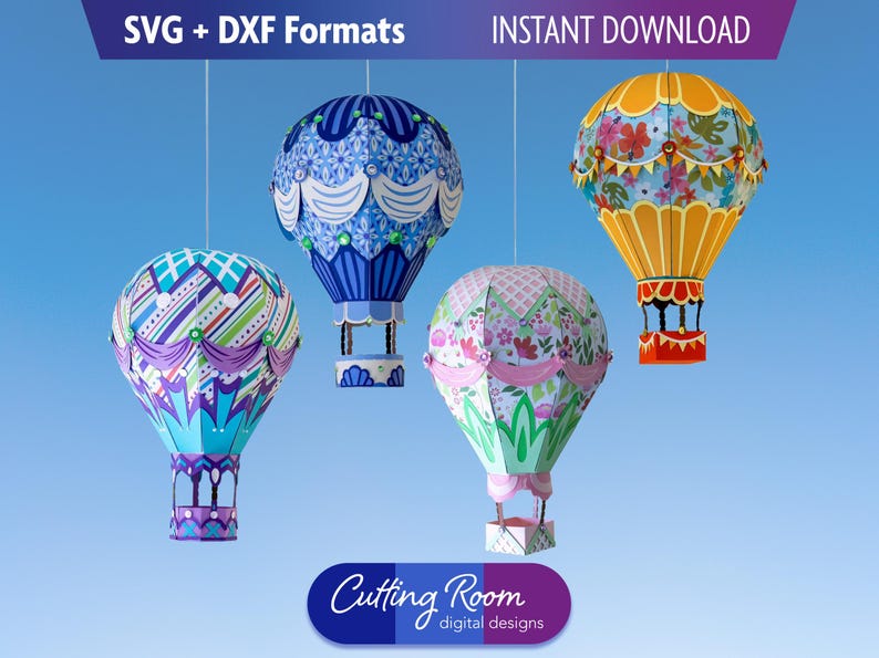 Four paper hot air balloons hanging from strings against a blue background. The balloons are decorated with different patterns and colors. The balloons are all different sizes. The balloons are labeled 'Cutting Room digital designs'.