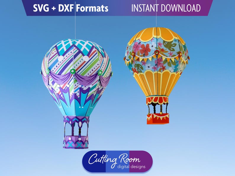 Two papercraft hot air balloons against aa blue background.  One is teal, purple and blue.  The other is yellow with floral accents.