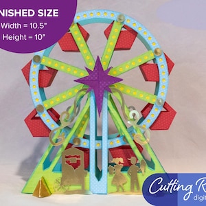 A papercraft model of a Ferris wheel with red and blue gondolas, green supports, and a purple star at the top. The model is on a green base with a gold cart and two figures standing in front of it.  There is a banner indicating that the Ferris wheel is about 10.5 inches wide and 10 inches tall.