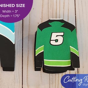 The small gift card box shaped like a hockey jersey has the number 5 displayed on the back.  There is a banner that says the box is 3 inches wide and 1.75 inches deep.