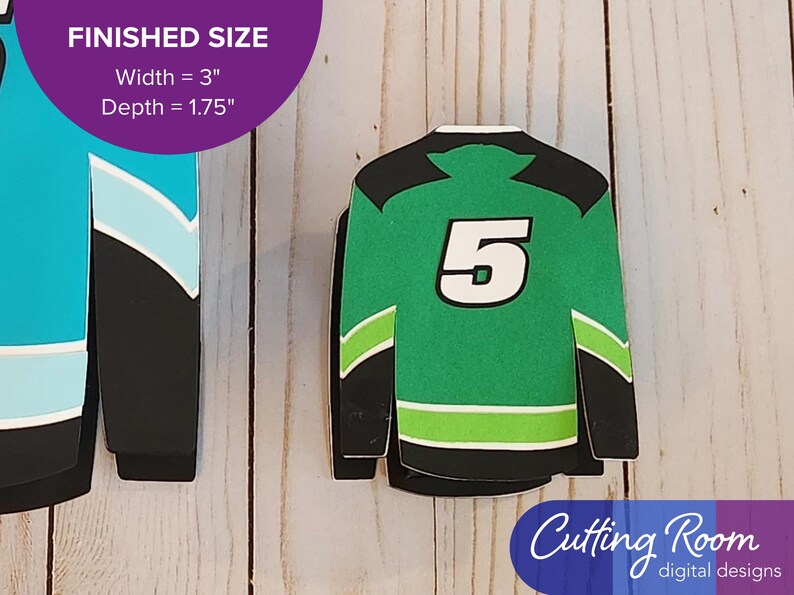 The small gift card box shaped like a hockey jersey has the number 5 displayed on the back.  There is a banner that says the box is 3 inches wide and 1.75 inches deep.