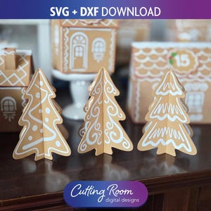 May include: Three-dimensional paper Christmas trees and gingerbread houses. The trees are tan with white decorative icing. The gingerbread houses are tan with white icing details. The image includes the text "SVG + DXF DOWNLOAD" and "Cutting Room digital designs."