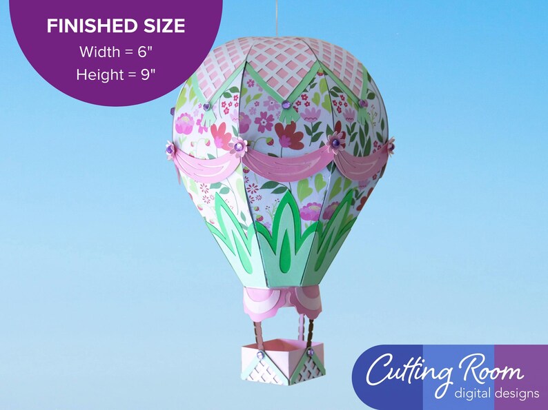 A pink paper craft hot air balloon with green and white accents.  A banner indicates that the balloon is about 6 inches wide and 9 inches tall.