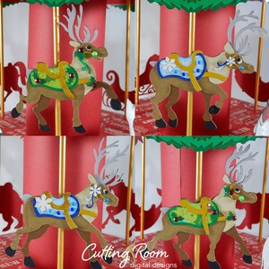 Four reindeer carousel horses, each with a different colored saddle and decorations. The reindeer are brown with grey antlers and are standing on a gold pole. The saddles are green, blue, light green, and white. The background is red with gold poles.