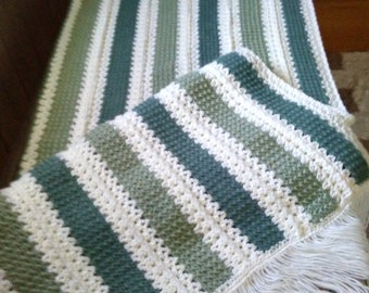 shades of green with white afghan in stripes
