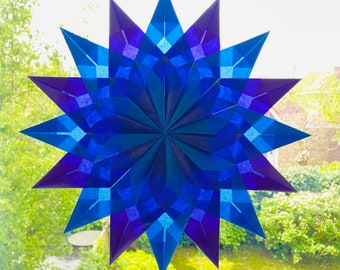 Waldorf window star. Paper star in purple and blue.