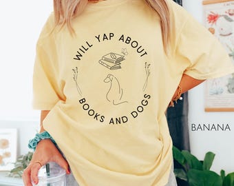 May include: A yellow t-shirt with a black graphic that says "Will yap about books and dogs". The graphic includes a stack of books and a dog.
