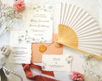 May include: Wedding invitation suite with a white background and black floral illustrations. The invitation features the names "Kelsey Elizabeth" and "Connor Caulderberry" with a date and location. The RSVP card features the text "Kindly Reply by July 1, 2022".