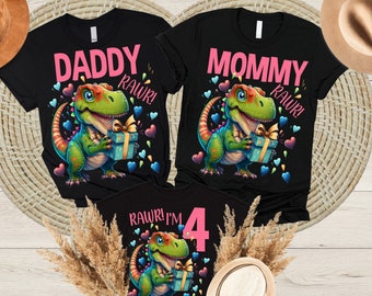 May include: Three black t-shirts with a dinosaur graphic and the words "Daddy Rawr!" "Mommy Rawr!" and "Rawr! I'm 4".