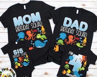 May include: A set of four black t-shirts with an under-the-sea theme. The shirts say "Mom Birthday Squad", "Dad Birthday Squad", "Sis Birthday Squad", and "I'm 4 Michael". Each shirt features an octopus, a whale, a turtle, and other sea creatures.