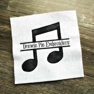 May include: Black and white embroidery design of a musical note with the text "Drewie Pie Embroidery" across the middle.