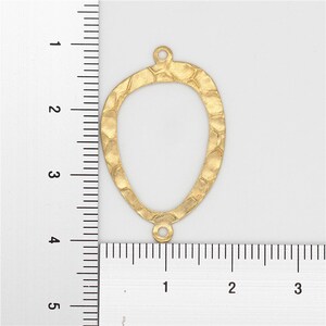 May include: Gold-toned metal pendant with a hammered texture and an oval shape. The pendant measures approximately 2 inches in height.