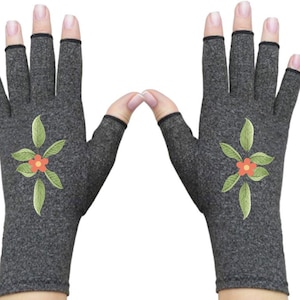 May include: A pair of gray fingerless gloves with a floral design. The gloves have a black trim and a small red flower in the center of the design.