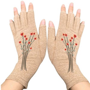 May include: A pair of beige fingerless gloves with an embroidered floral design. The gloves feature a cluster of red flowers with green leaves and brown stems. The gloves are designed to cover the hand and wrist, leaving the fingers exposed.