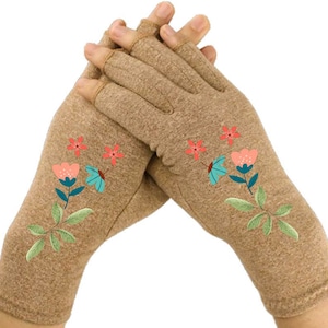 May include: A pair of brown fingerless gloves with a floral embroidery design. The flowers are pink, blue, and green.