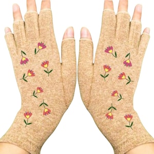 May include: A pair of beige fingerless gloves with a floral pattern. The flowers are pink, red, and yellow.