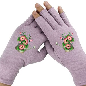 May include: A pair of lavender fingerless gloves with a floral design. The design features a watering can filled with pink flowers.