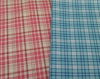 May include: Two fabric swatches, one pink and white plaid and one blue and white plaid.