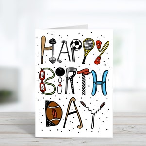 May include: A white card with black polka dots and the words "Happy Birthday" spelled out using various sports equipment illustrations. The letters are in black, red, blue, green, and brown.