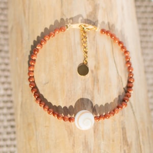gold sand stone and pacific eye of saint lucia bracelet