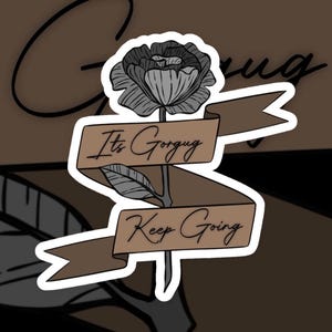 Puede incluir: Una pegatina con una rosa en blanco y negro con una pancarta marrón que dice "It's Gorguq Keep Going".