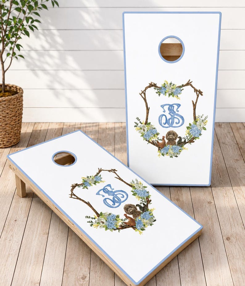 the perfect personalized wedding gift, groomsman gift, or unique addition to your wedding celebration. This beautiful monogram cornhole set features a white finish with an elegant blue and white floral wreath surrounding your custom monogram.  Each custom game board is personalized with your initials, making it a one-of-a-kind keepsake. Whether you're looking for custom logo boards a cornhole score board or stylish corn hole boards, this premium cornhole board set is built to impress.
