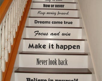 May include: White stairs with black motivational quotes on each step. The quotes are: "Do it now", "Never give up", "Keep it cool", "Now or never", "Keep moving forward", "Dreams come true", "Focus and win", "Make it happen", "Never look back", and "Believe in yourself".