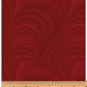 May include: Red fabric with a swirling, marbled pattern. The fabric is shown with a ruler for scale.
