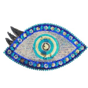 Peut inclure: Un charme &oelig;il-de-dieu bleu et argent&eacute; fait de paillettes. L'&oelig;il est entour&eacute; d'un cercle bleu et d'un cercle argent&eacute;. Le charme est un symbole populaire de protection et de bonne chance.