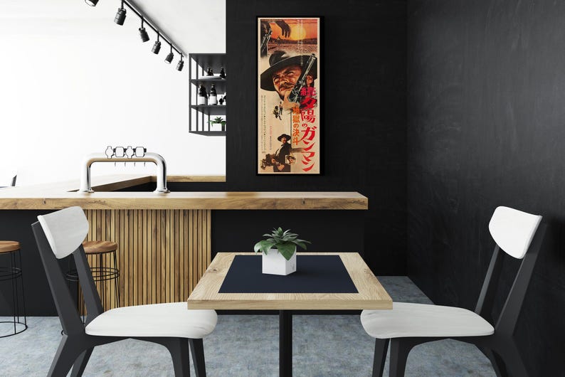 a modern, minimalist interior design with a black and white color scheme. A large poster of a man is prominently displayed on the wall, adding a unique visual element to the space. In the foreground, there is a wooden table with two white chairs, creating a cozy seating area. The overall design has a sleek and contemporary feel, with the black and white color palette contributing to the overall aesthetic.
