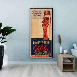 a framed vintage poster of a woman in a red dress, hanging on a wall in a living room setting.