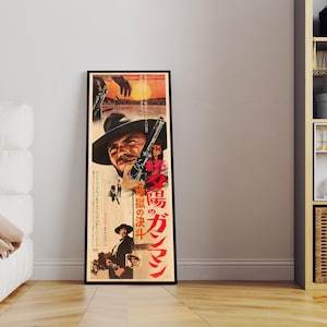 a framed movie poster of a man with a gun, standing in a room with a white couch and a bookshelf.