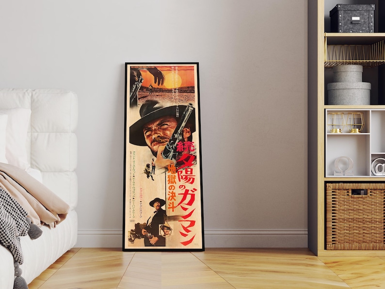 a framed movie poster of a man with a gun, standing in a room with a white couch and a bookshelf.