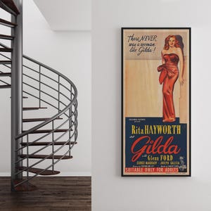 a spiral staircase and a framed vintage poster of Marilyn Monroe on the wall.