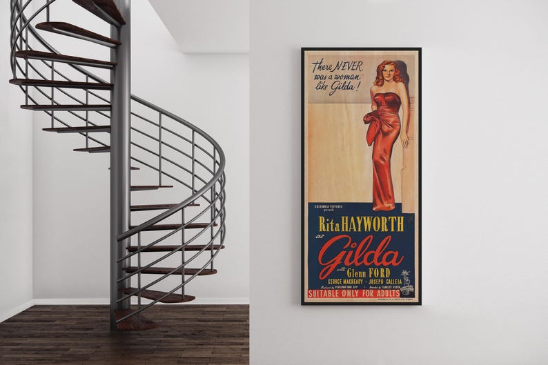 a spiral staircase and a framed vintage poster of Marilyn Monroe on the wall.