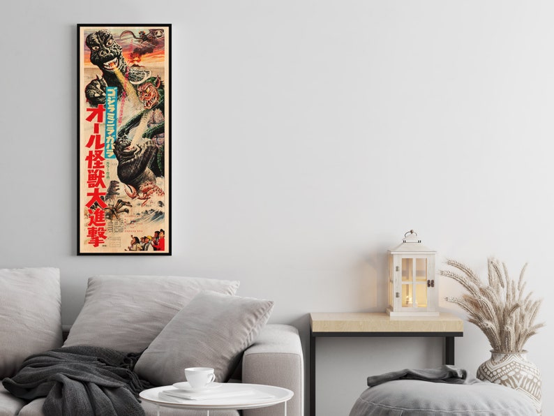 a living room with a gray couch and a poster on the wall