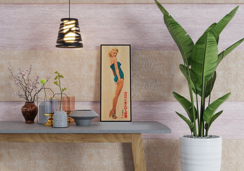 a picture of a woman in a bathing suit on a shelf next to a plant