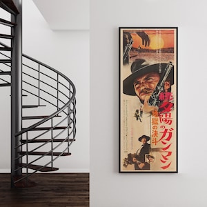 a spiral staircase and a framed poster of a movie poster for "The Magnificent Seven" on a wall.