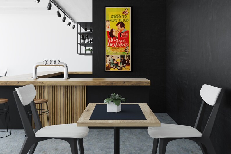 a kitchen with a table and chairs and a poster on the wall
