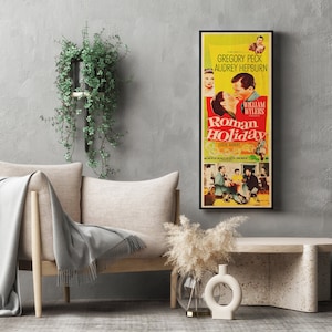 a movie poster hanging on a wall next to a couch