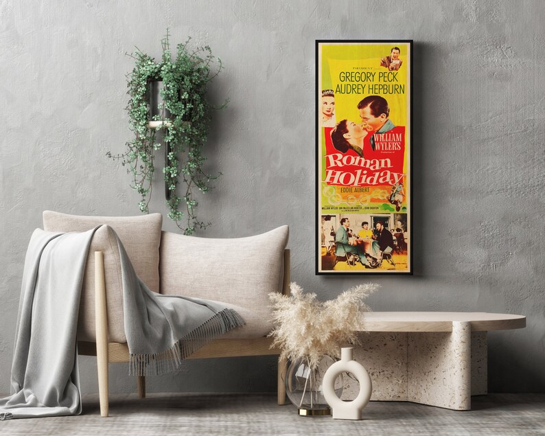 a movie poster hanging on a wall next to a couch