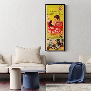 a living room with two couches and a poster on the wall