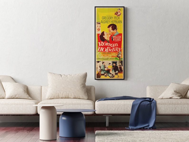 a living room with two couches and a poster on the wall