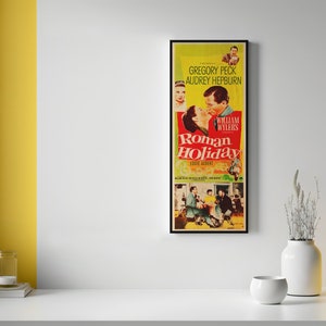 a yellow vase sitting next to a poster on a wall
