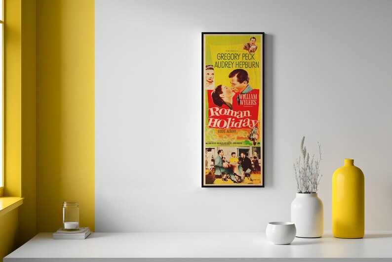 a yellow vase sitting next to a poster on a wall