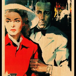 May include: A vintage film poster for the movie Casablanca, starring Humphrey Bogart and Ingrid Bergman. The poster is in a retro style with a yellow and black colour scheme. The text on the poster reads "Casablanca" with the names of the actors and the director below.