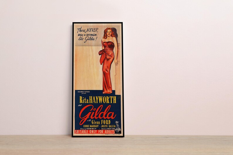 The image is a framed vintage advertisement featuring a woman in a red dress.
