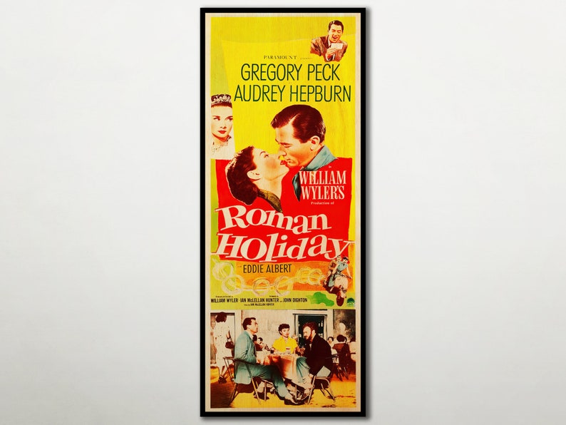 May include: A framed movie poster for "Roman Holiday" featuring Gregory Peck and Audrey Hepburn. The poster has a yellow background with red and white text. The image shows the actors kissing, with other scenes and text.