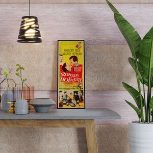 a table with a plant and a movie poster on it